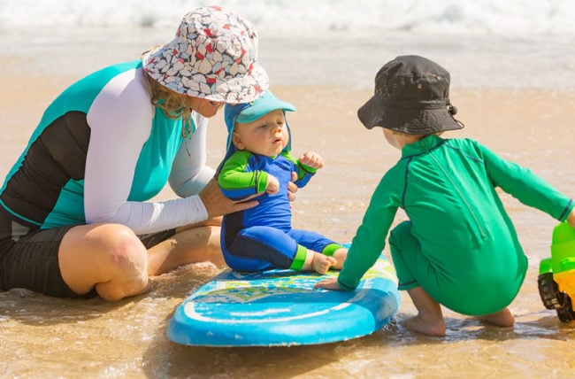 family-at-beach-in-sun-protectant-clothing