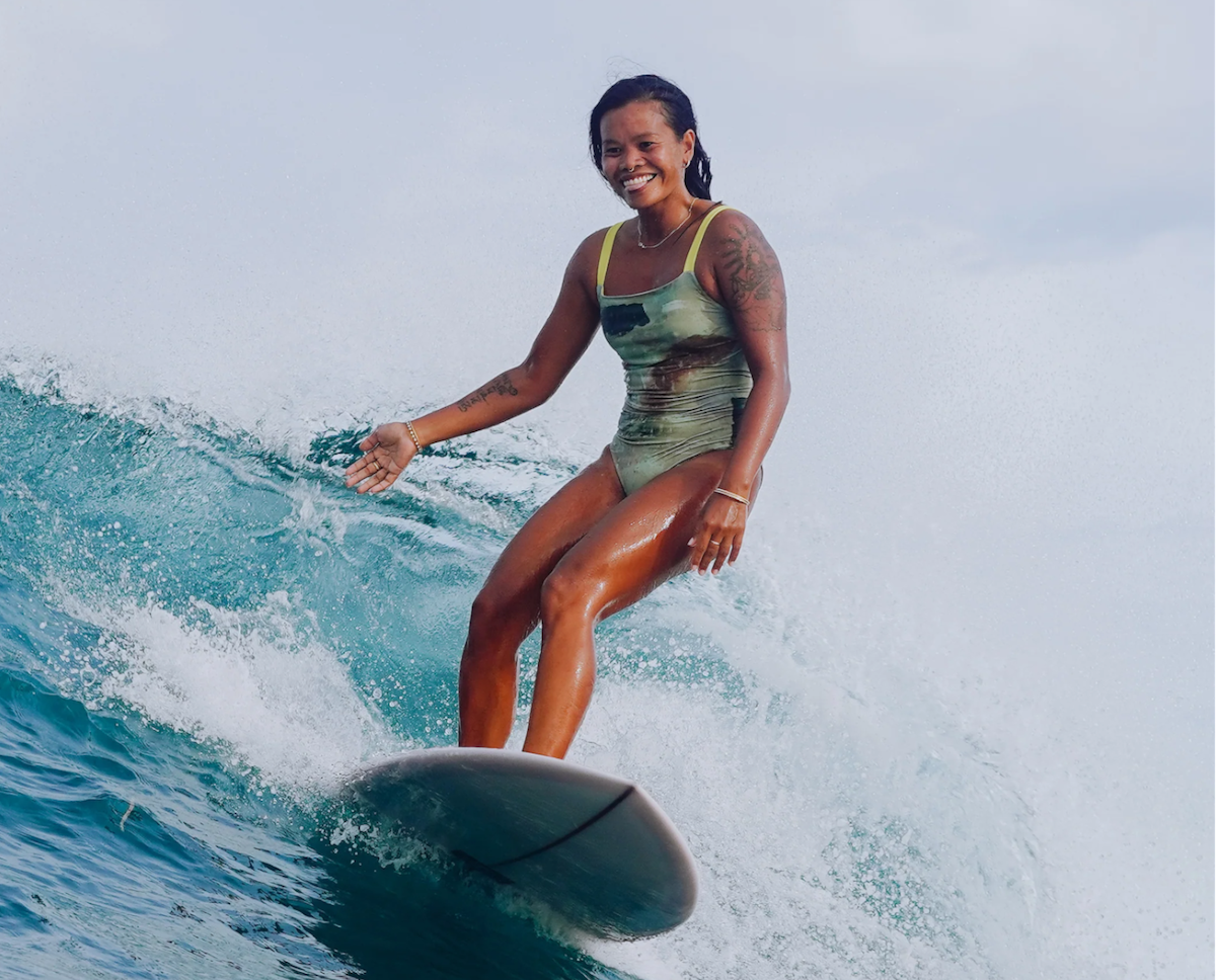 girl-surfing-one-piece-swimsuit