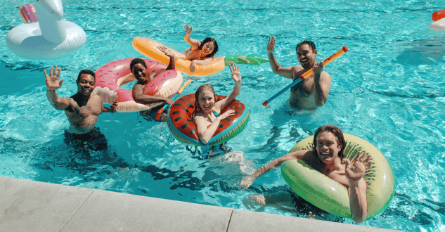 family with floaties in swimming pool-min