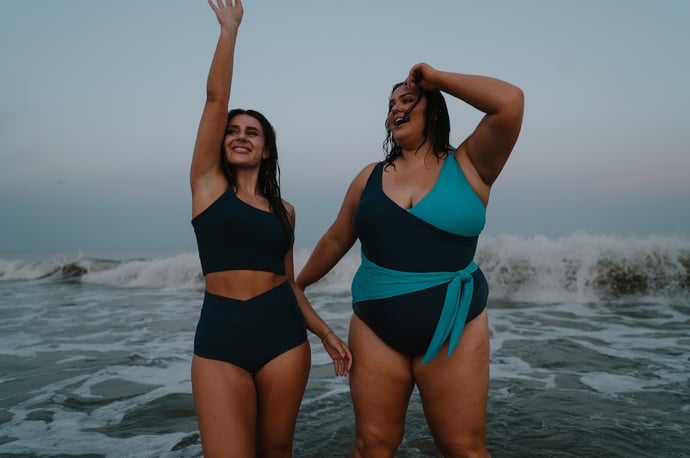 women-in-swimsuits-splashing-in-ocean-water